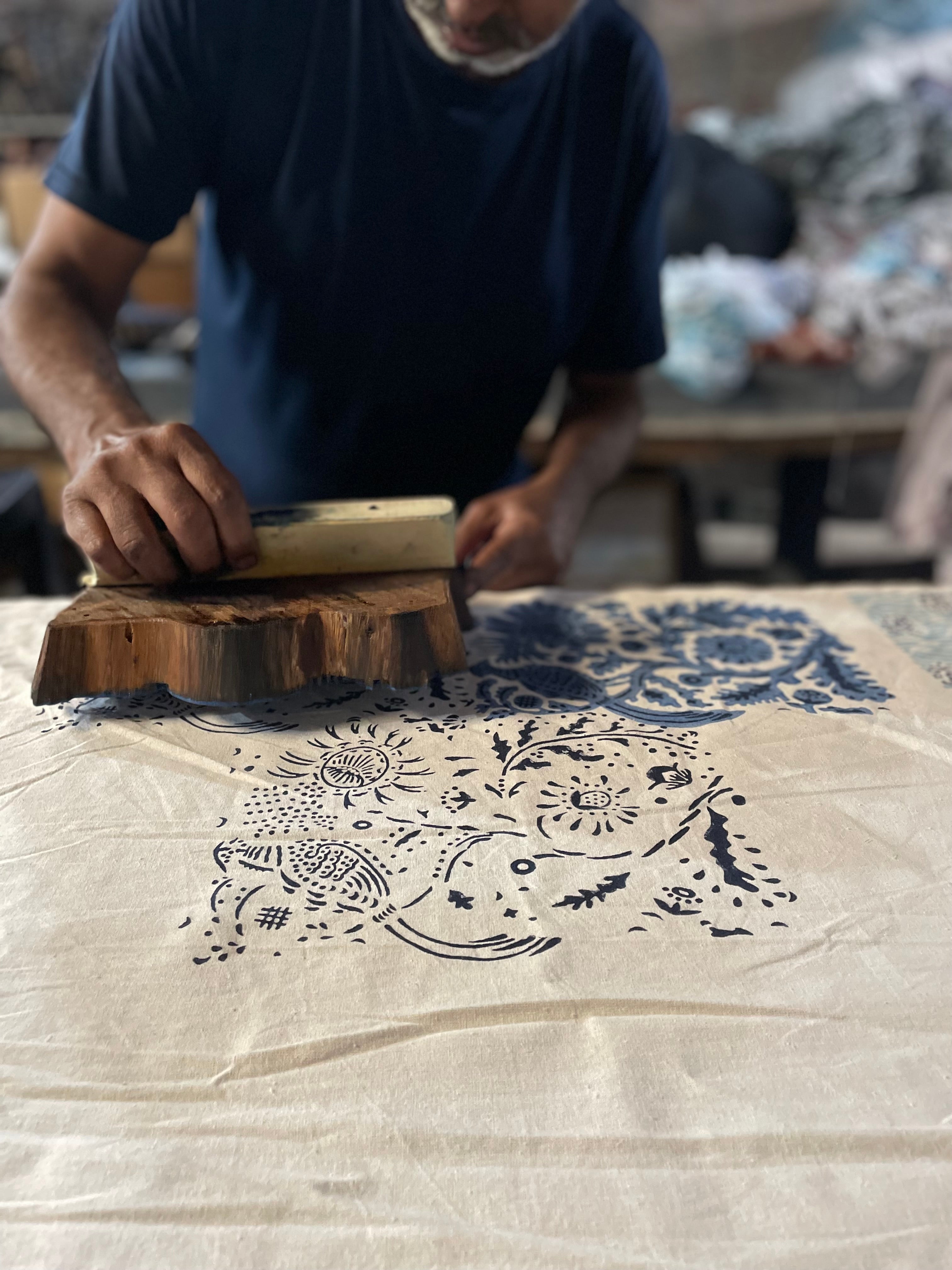 Person block printing on cloth