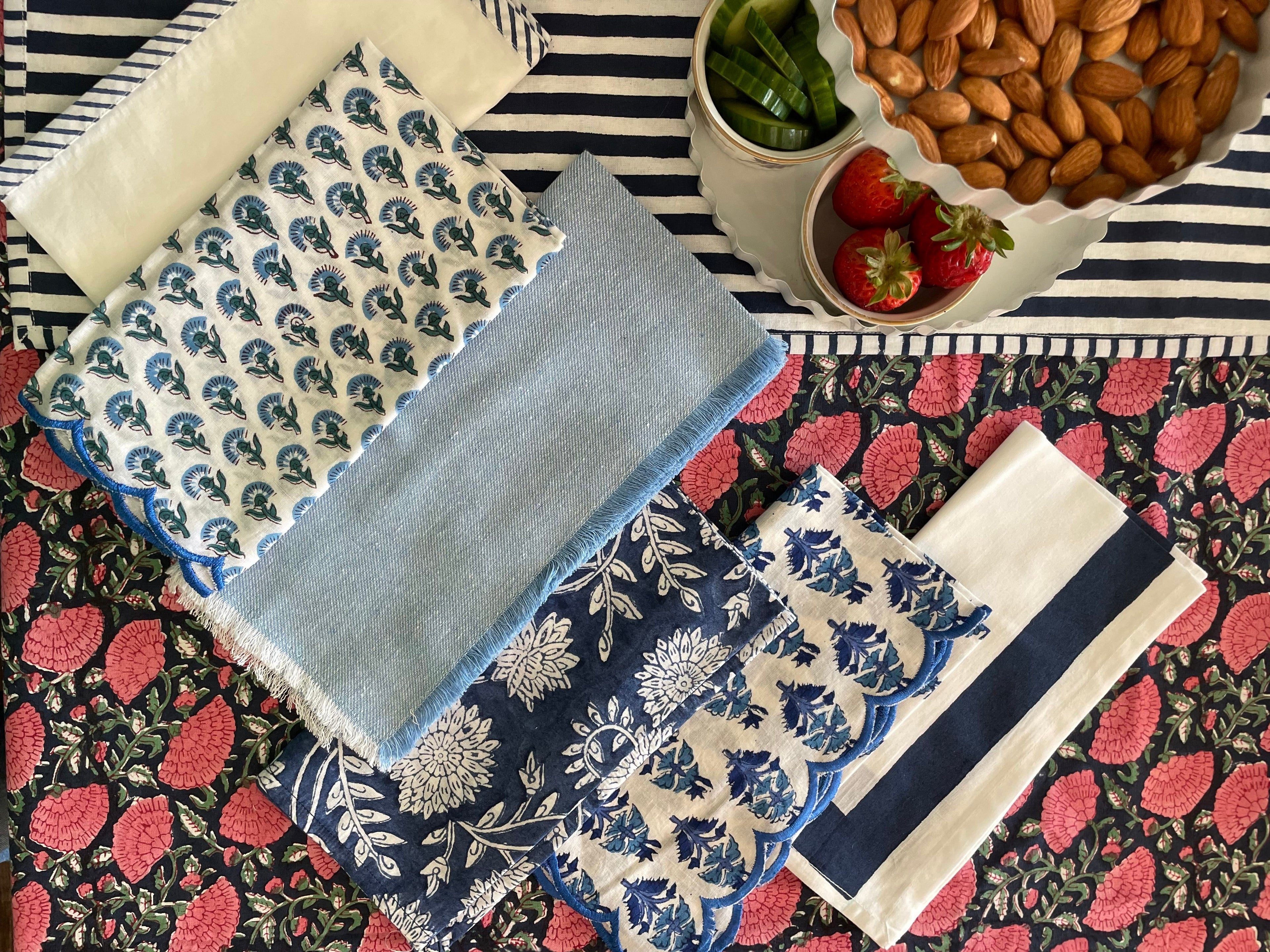 Fabric napkins and tablecloth with floral patterns on a colorful background