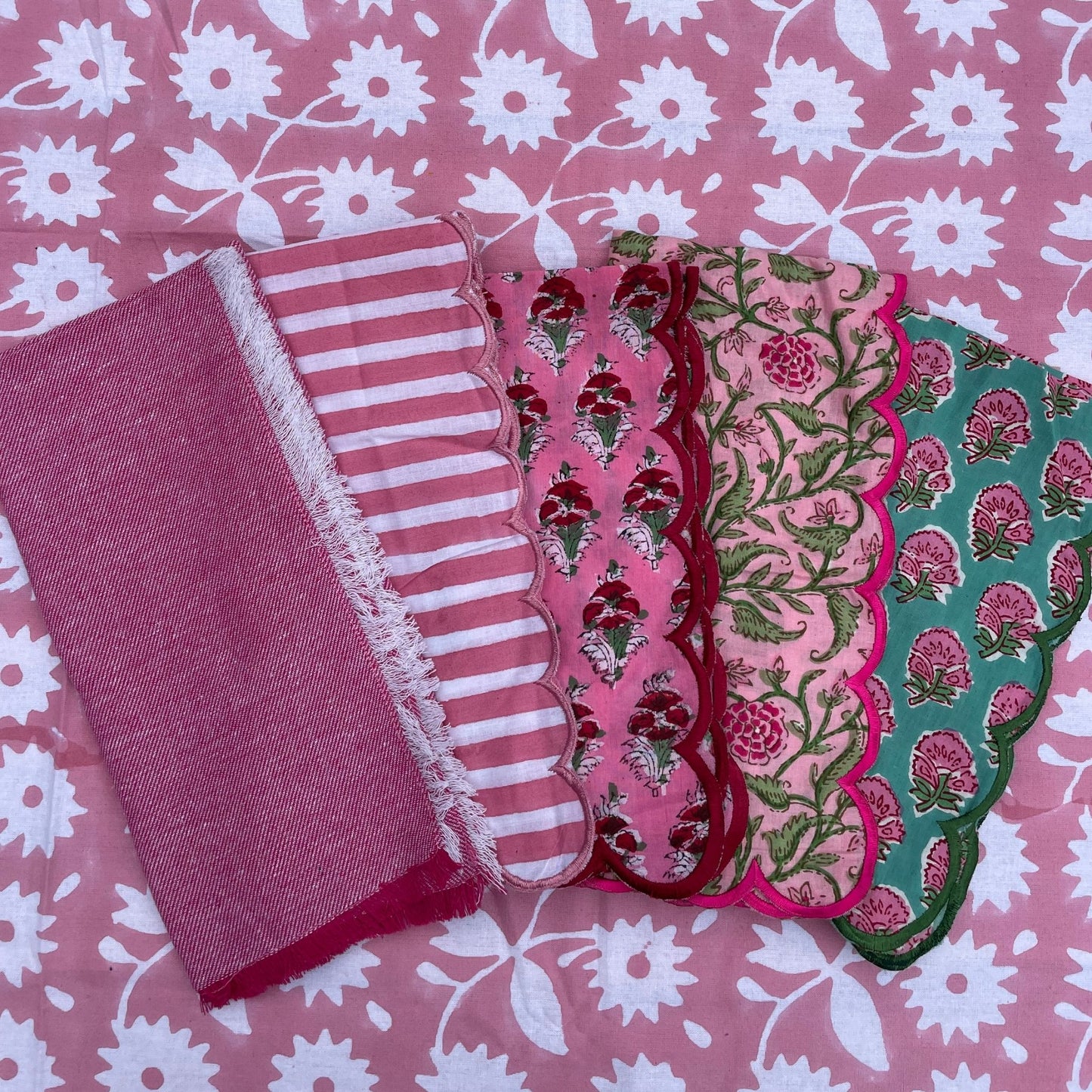 Set of colorful fabric samples on a pink floral background